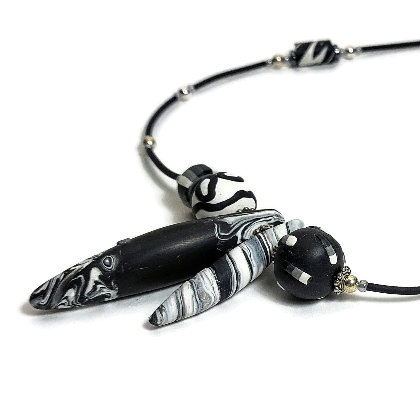 Detail of polymer clay beaded necklace on white background