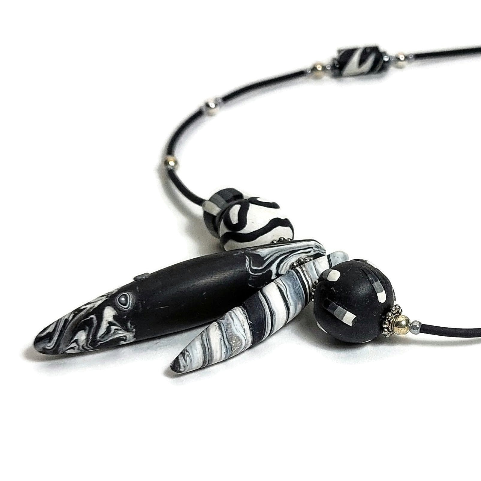 Detail of polymer clay beaded necklace on white background