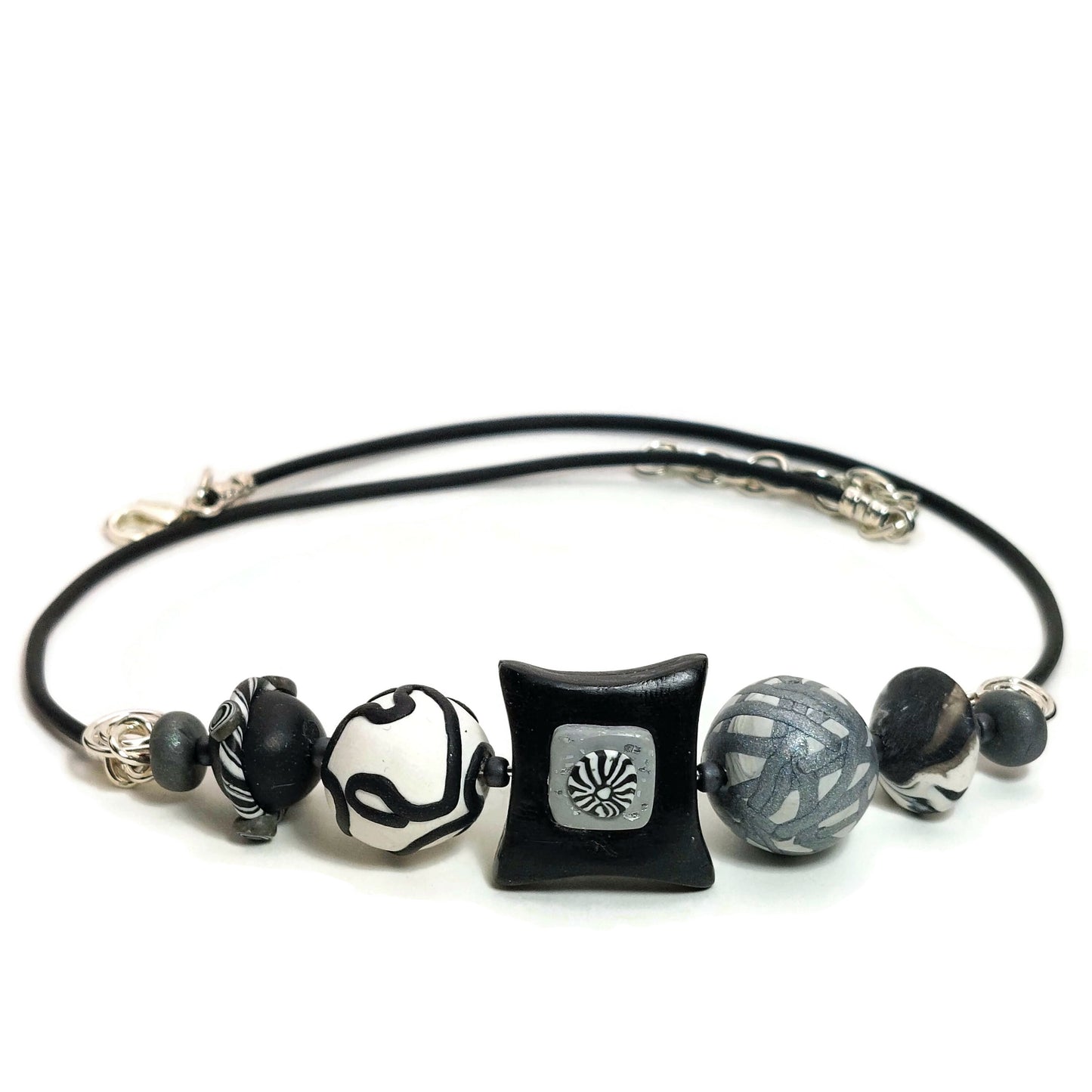 Polymer clay bead necklace with silver-filled clasp on white background