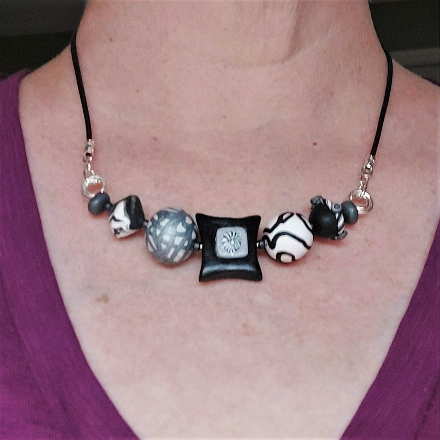 Polymer clay bead necklace on woman's neck