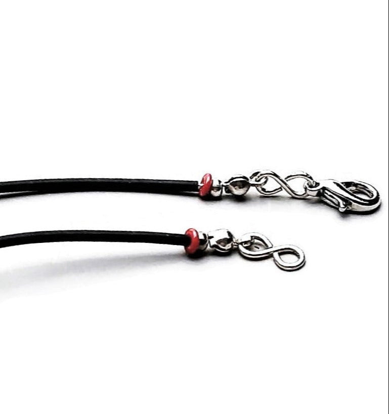 Detail of sterling silver lobster clasp on white background