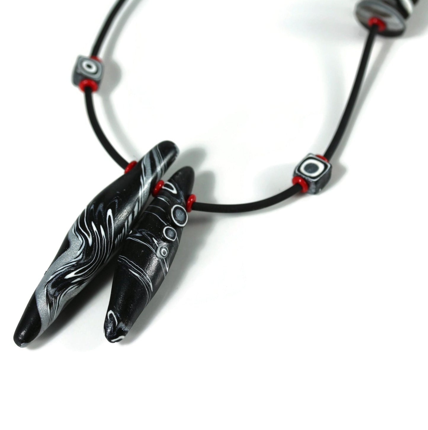 Detail of polymer clay bead necklace on white background