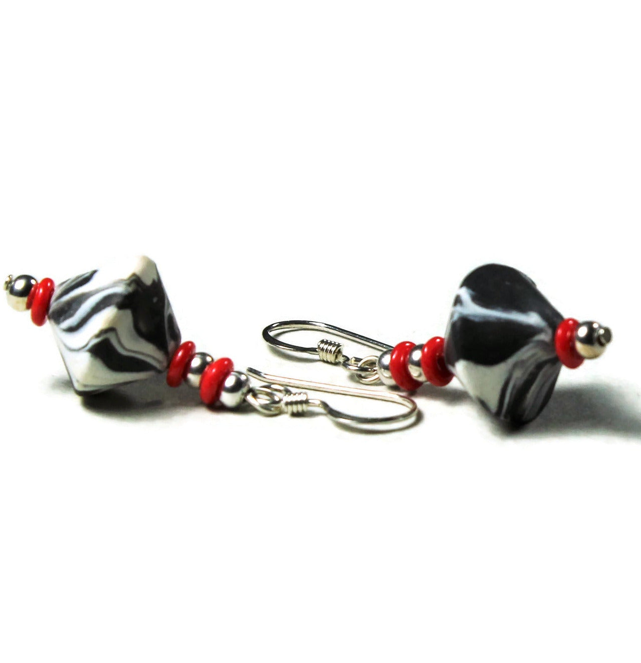 Polymer clay bicone earrings with sterling silver ear wires on white background