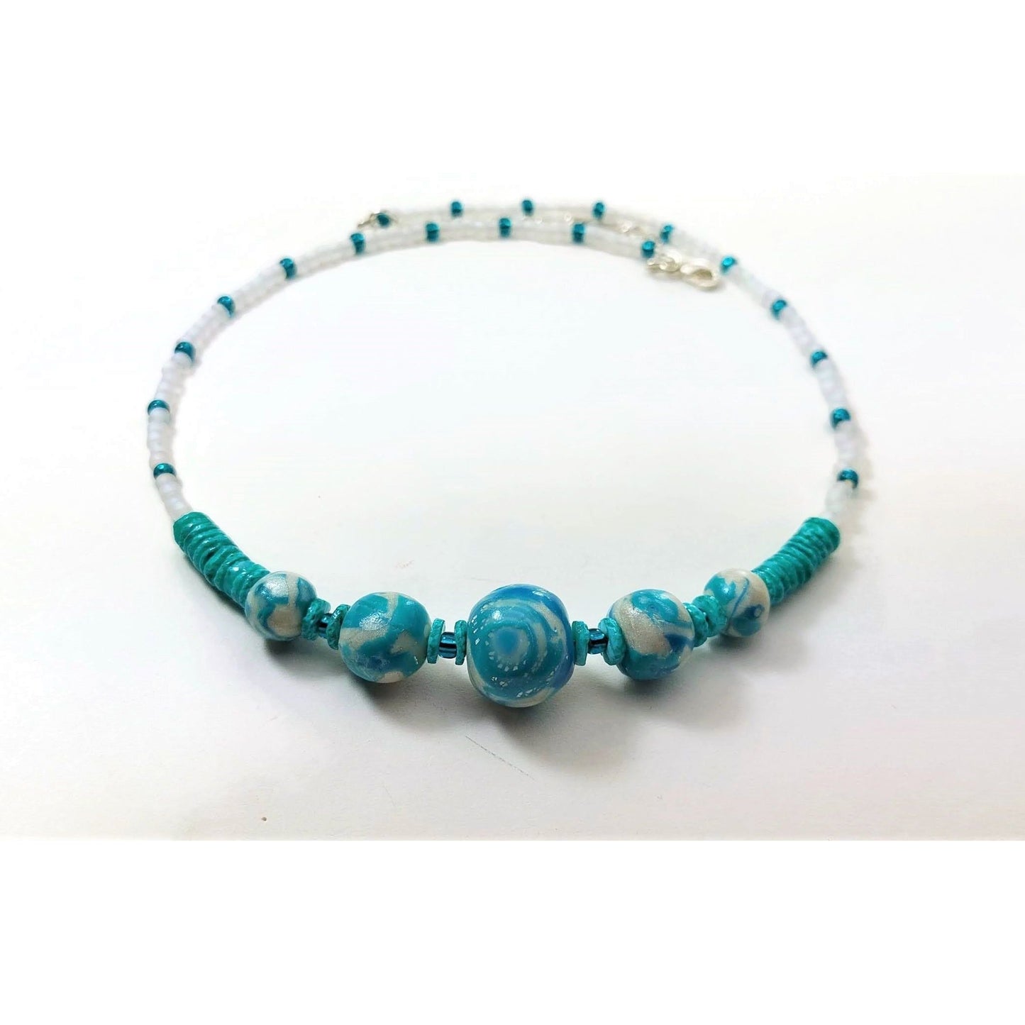 Polymer clay necklace accented with turquoise howlite gemstone and glass beads, extension chain and sterling silver lobster clasp.