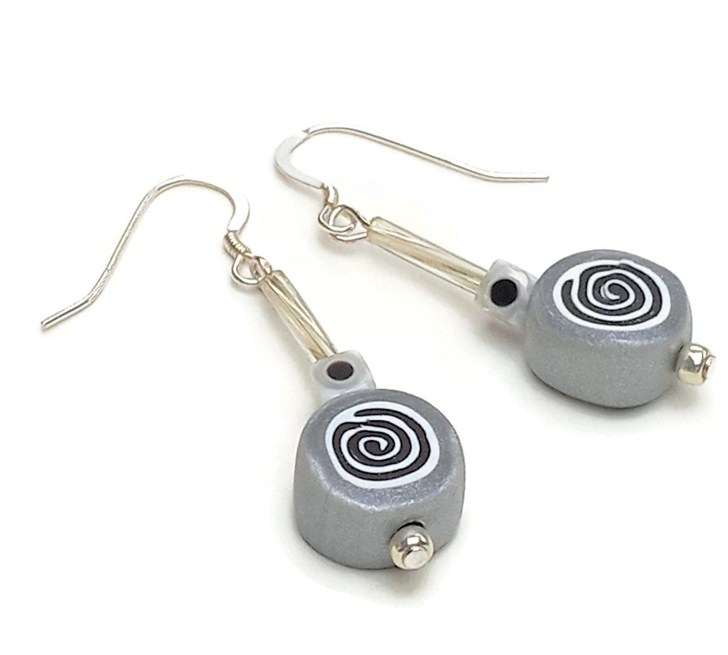Polymer clay spiral bead drop earrings with sterling silver ear wires on white background
