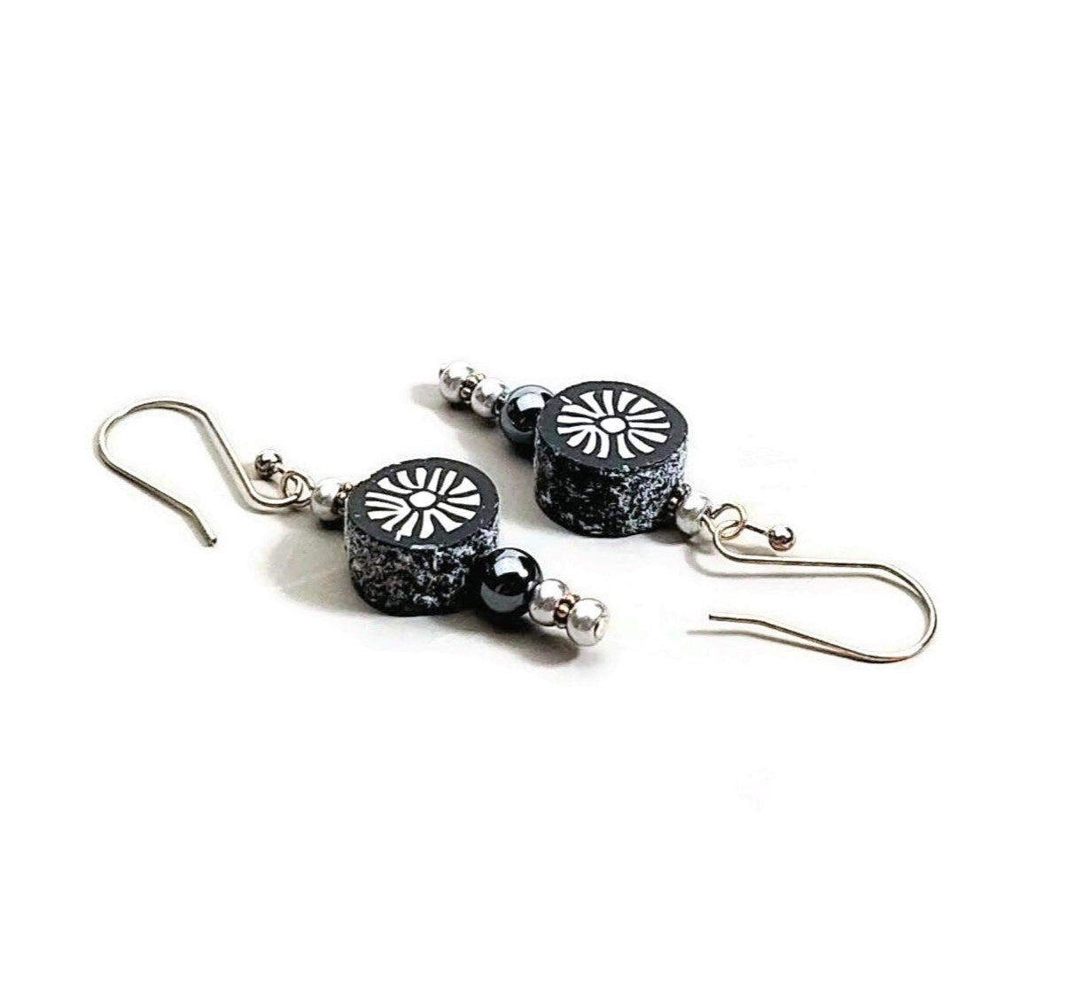Polymer clay sunburst disk and hematite gemstone drop earrings with sterling silver ear wires on white background