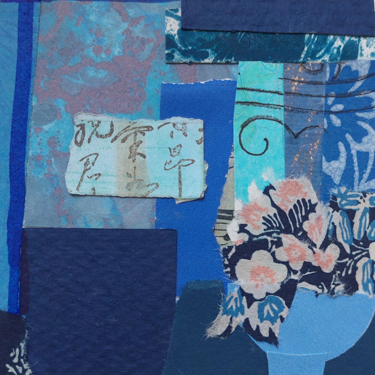 A close-up of a blue and tea collage artwork featuring layered paper textures, floral patterns, with rubber stamped text.