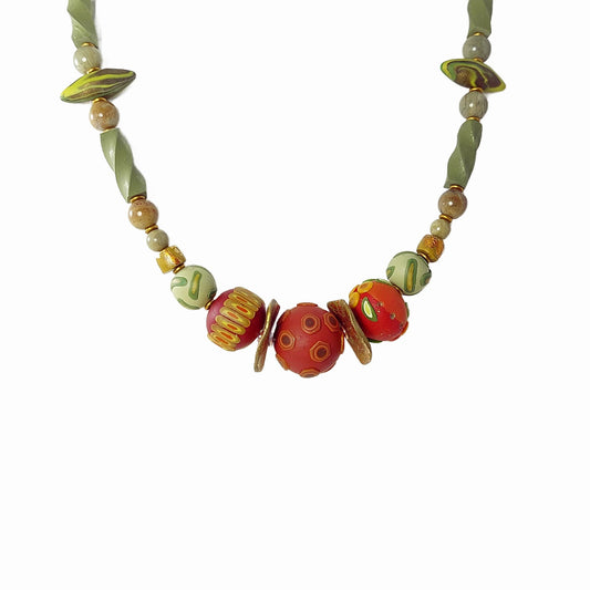 The elegant Sage and Spice Necklace features three russet hued focal beads  detailed on surface with a mix of leaf, berry, and pod shapes. Accented with a mix of green polymer clay beads, silver leaf jasper gemstone beads, and matte gold disks.  Button and loop closure. Lightweight. Free shipping in the US.