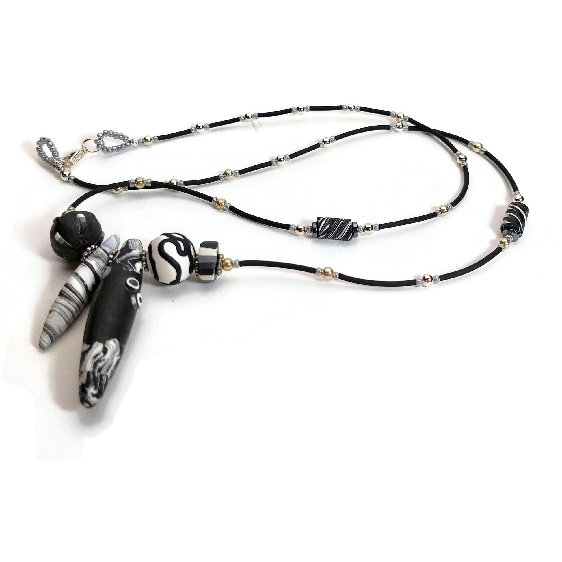 Black and white polymer clay necklace with silver-filled lobster clasp on white background