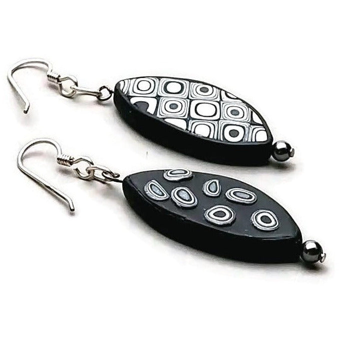 Reversible elliptical polymer clay earrings on white background