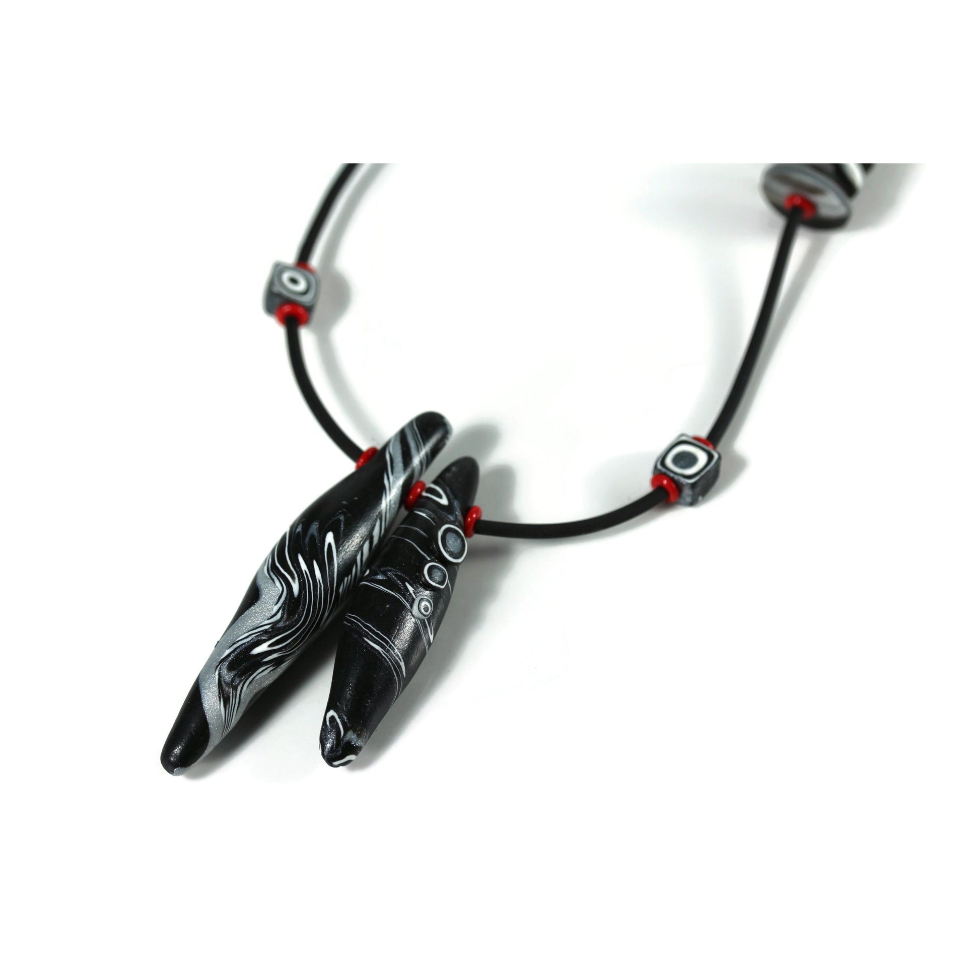 Detail of polymer clay bead necklace on white background