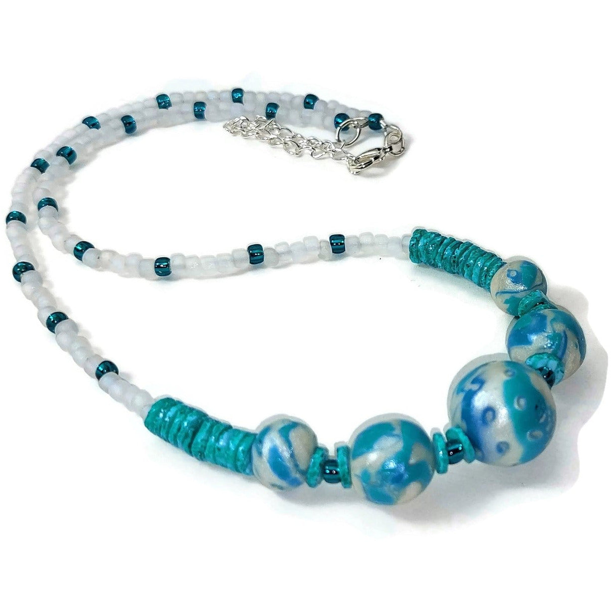 Polymer clay, glass, and howlite gemstone bead necklace with sterling silver lobster clasp on white background