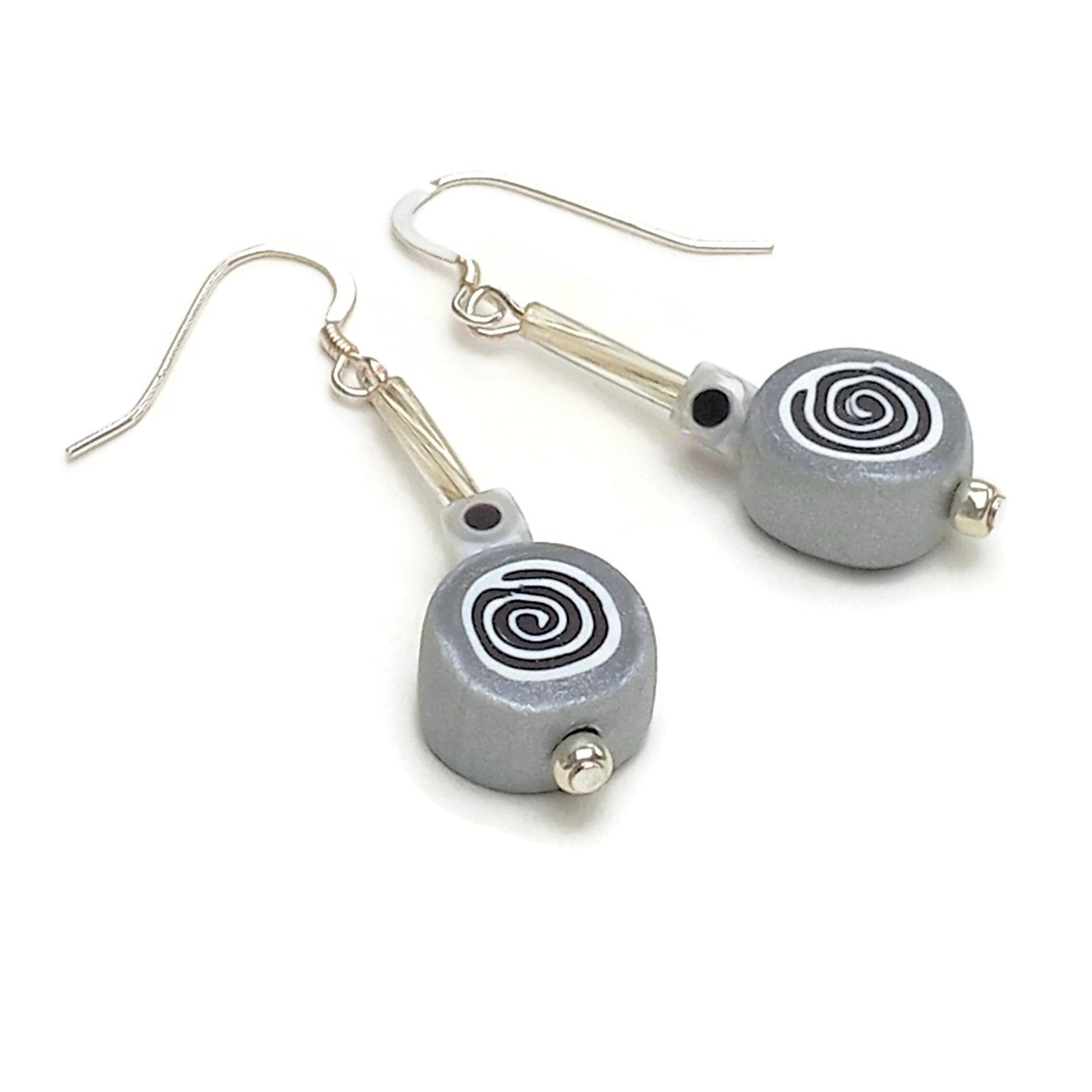 Polymer clay spiral bead drop earrings with sterling silver ear wires on white background