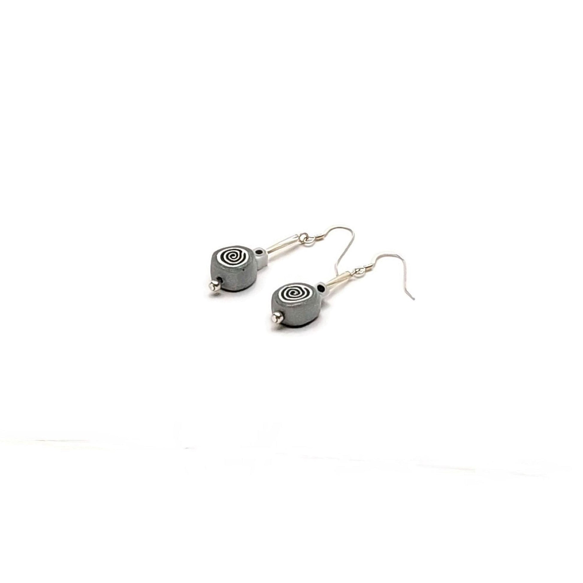 Polymer clay spiral bead drop earrings with sterling silver ear wires on white background